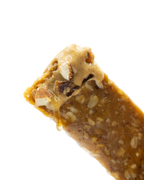 Close-up of a peanut butter protein bar with visible nuts on a white background